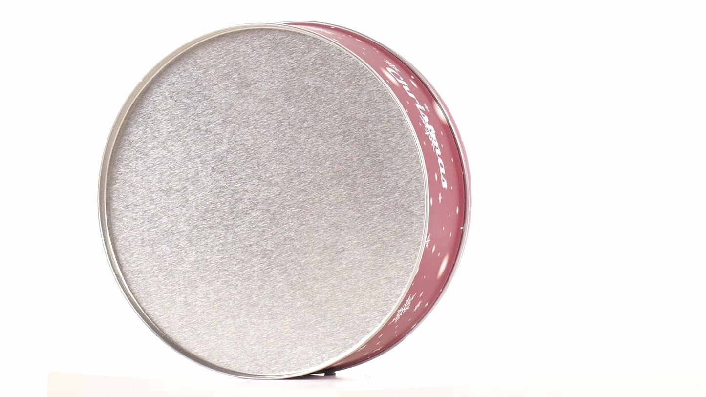 Round red metal tin with Christmas reindeer pattern