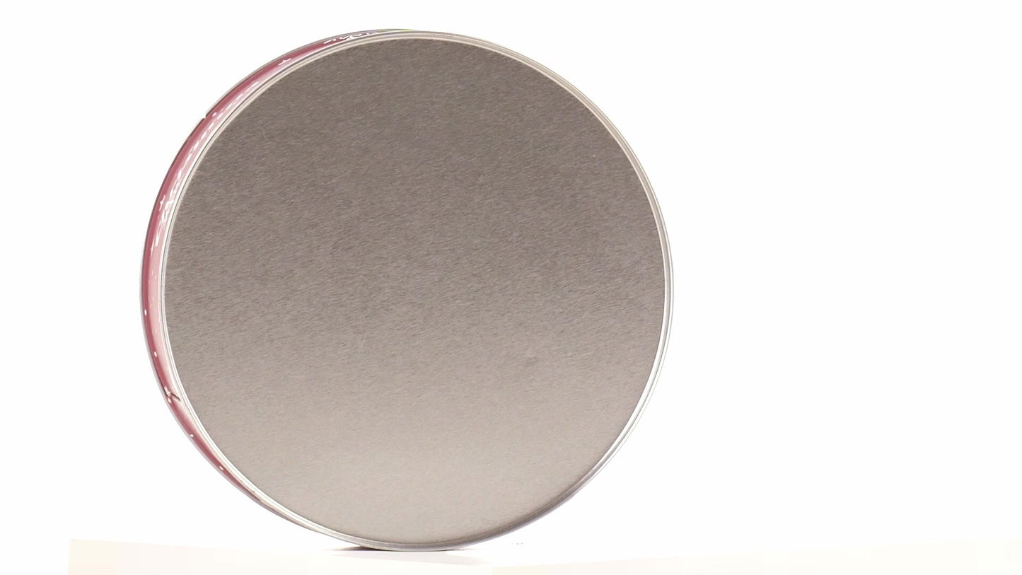 Round red metal tin with Christmas reindeer pattern
