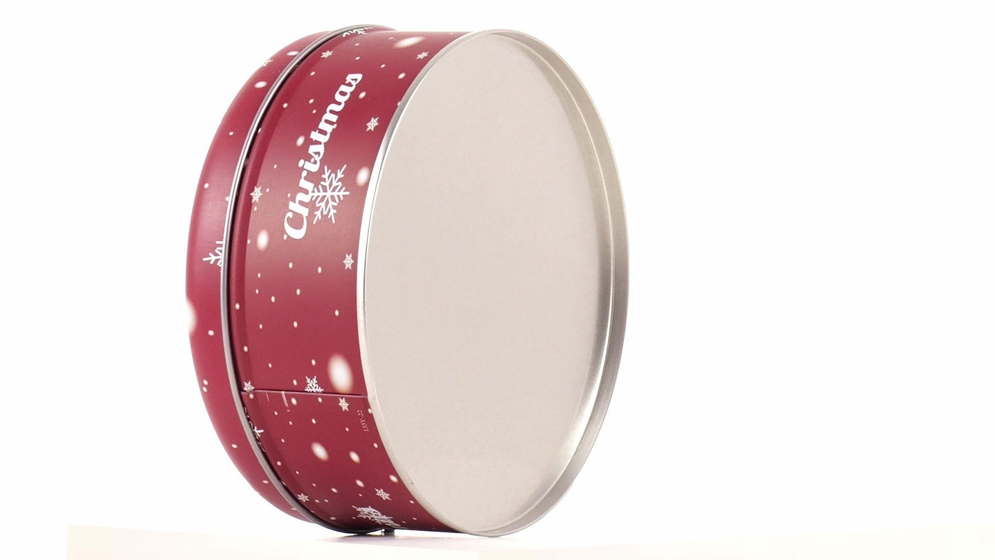 Round red metal tin with Christmas reindeer pattern